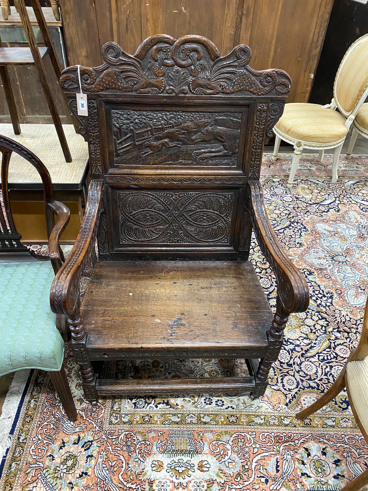 An 18th century and later carved oak wainscot chair, width 77cm, depth 65cm, height 120cm